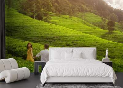 Aerial Drone View of Walking Couple of Travelers on Green Tea Plantations Wall mural