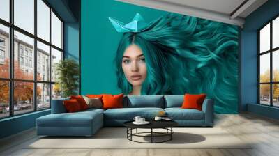 A woman with long teal hair floating with an origami boat Wall mural