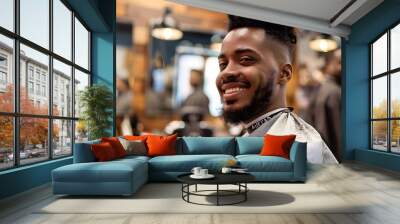 Black man sitting at a barbershop getting haircut smiling Wall mural