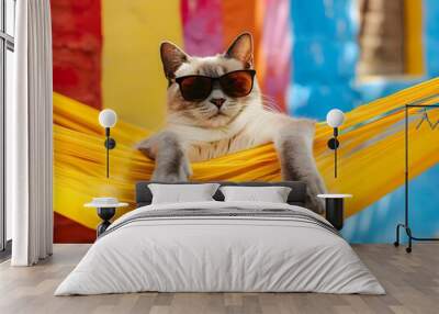 Chill cat in sunglasses relaxing in a yellow hammock Wall mural