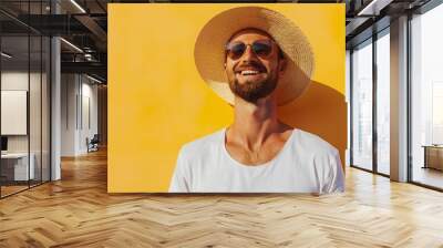 Happy summer man in a stylish straw hat on yellow wall Wall mural