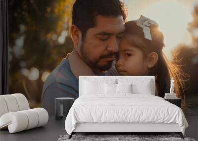 In the park a Hispanic father lovingly embraces his young daughter as they share a heartwarming moment outdoors gazing into each other s eyes with bright smiles Wall mural