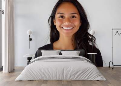 Latin American woman using smartphone smiling on white background Wall mural