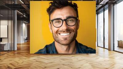 Man wearing glasses smile happy face portrait with yellow background Wall mural