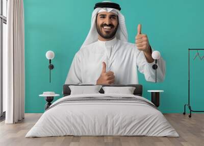 Smiling Man in Traditional Arab Attire Giving Thumbs Up Wall mural