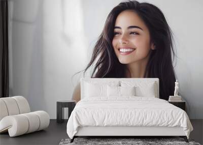 young woman with long dark hair poses confidently on white background Wall mural