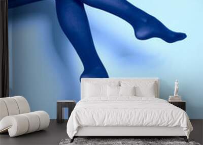 Beautiful woman legs in blue tights Wall mural