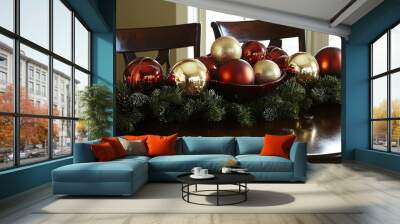 Festive table centerpiece featuring gold and red ornaments with pine garland during the winter holiday season Wall mural