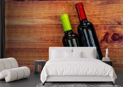 Top view of two wine bottles on a rustic wood table with copy space. Wall mural