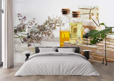 Two bottles of oil, skin care, aromatherapy, stand on a wooden stand, dried flowers Wall mural