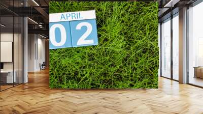 April 2nd. Day 2 of month, calendar on football green grass background. Spring time, empty space for text Wall mural