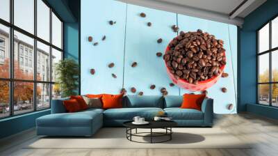 Coffee beans in red bowl on wooden background Wall mural