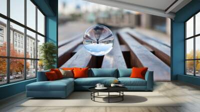 Glass transparent ball on wooden slats background. With empty Wall mural