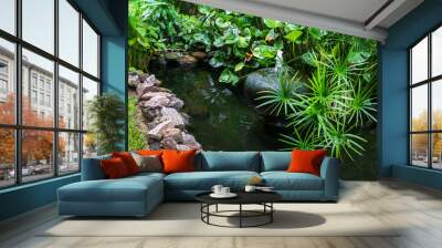 Decorative pond with fountain in garden Wall mural