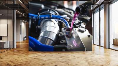 Auto mechanic filling pre-mixed long life coolant fluid in to aluminum radiators. Wall mural