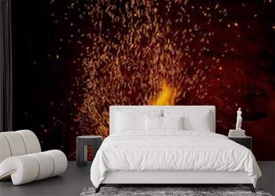 Sparks of a fire on a black background Wall mural