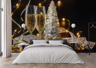 Two glasses of champagne or wine with bokeh background with christmas ball and tree Wall mural