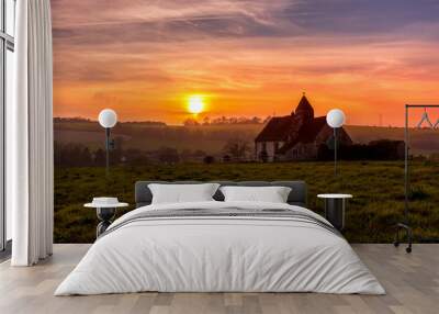 Sunset over the South Downs National Park at Idsworth with the ioslated  St Hubert's church, Hampshire, UK Wall mural