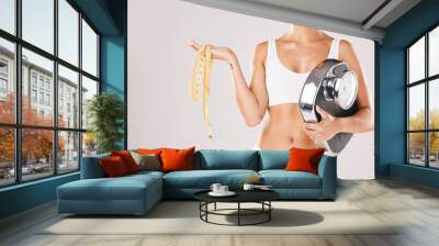 Woman, fitness and scale with measure tape, weight loss and happy for success, achievement and health goal. Model, body and healthy anatomy with smile, wellness and self care by studio background Wall mural