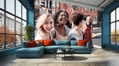 A Group of diverse students having fun outdoors in the city on a sunny summer day. Portrait of young people or friends laughing and smiling together in an urban town while walking to campus Wall mural