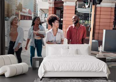 Casual, diverse students walking in the city and chatting or having fun together in town during a university campus break. Cheerful, happy group of friends enjoying an outdoor meeting or hanging out. Wall mural