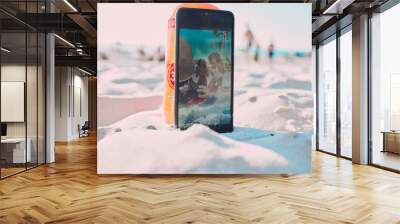 Phone, sand and friends taking a picture on the beach while on a summer vacation together. Travel, fun and women with freedom taking a selfie on smartphone while on seaside holiday adventure by ocean Wall mural