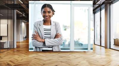 Business woman standing with arms crossed, looking proud and confident in an office alone at work. Portrait of a young black female manager, boss or employee smiling, looking successful and powerful Wall mural