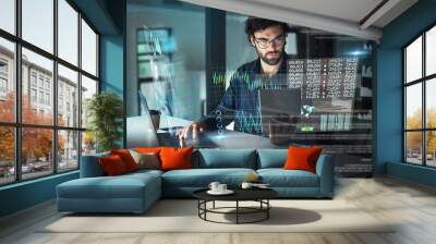 Digital, night and a businessman with technology for the stock market, finance analysis and research. Data, office and an employee reading statistics, stocks and analytics in the dark on tech at work Wall mural