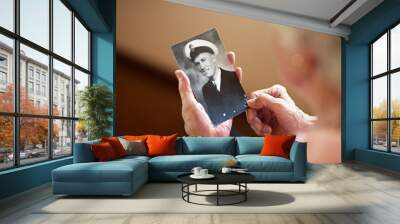 He lived a life of honor. Cropped shot an elderly woman holding an old black and white photograph of a man. Wall mural