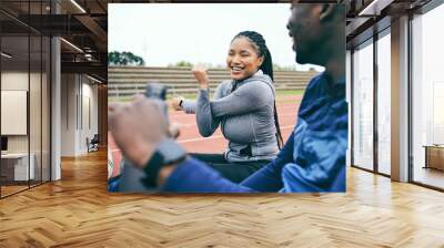 People, fitness and stretching for sports exercise, workout or training together on the stadium track. Black woman and friends in warm up stretch getting ready for athletics sport, running or race Wall mural