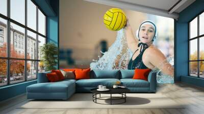 Water polo, cardio and portrait of a woman with a ball for a competition, game and training. Fitness, strong and athlete girl throwing with power, action and playing during a professional match Wall mural