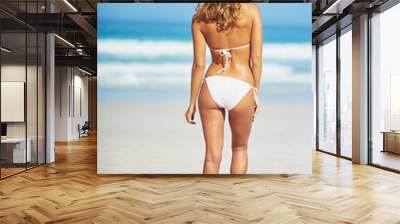 Ocean, beach and back of woman in swimsuit for summer vacation, travel destination and tropical island. Bikini, nature and person by waves, sea and blue sky for holiday, adventure and relax in Hawaii Wall mural