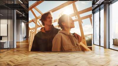 couple standing inside wooden frame construction of their future home. construction Wall mural