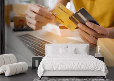 Close up hand man holding and choosing credit card to use. Man use credit cards for shopping online. Wall mural