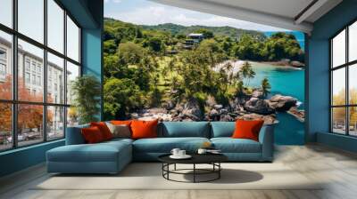 Aerial view of a paradise beach or coves where the waves of the sea break on the rocks. Top view of a tropical coast with vegetation, few buildings, turquoise blue water on sunny day. Summertime. Wall mural