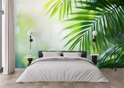 Close-up of green palm leaves with sunlit bokeh background. Nature and tranquility concept Wall mural