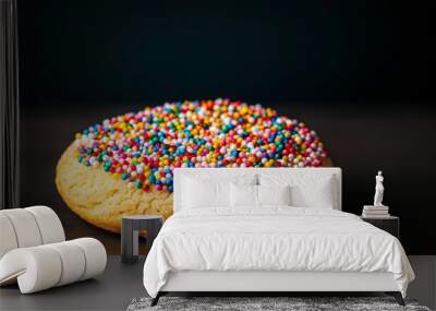 Colorful sprinkled cookie on dark background, dessert photography concept Wall mural