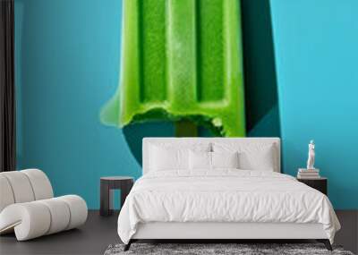 Green popsicle on a blue background Wall mural