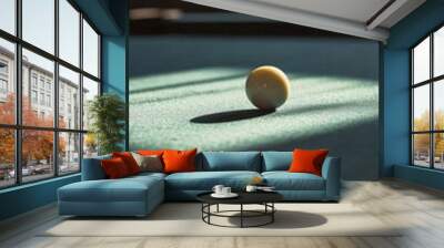 Single billiard ball on pool table with dramatic lighting, focused and minimalistic concept Wall mural