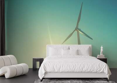 Wind turbine against clear sky with sun, renewable energy concept Wall mural