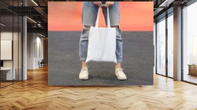 model hold blank white fabric tote bag for save environment on street fashion Wall mural