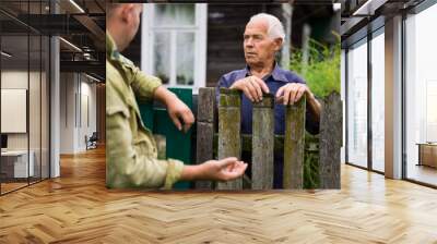 Senior man having conversation with his neighbour Wall mural