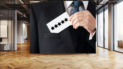 Businessman takes out a business card from his pocket with the five star rating icon. Wall mural