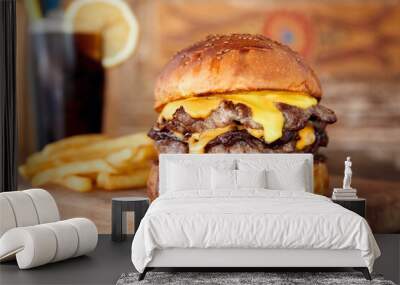 Delicious homemade cheeseburger or hamburger on wooden tray with coke and fires. Wall mural