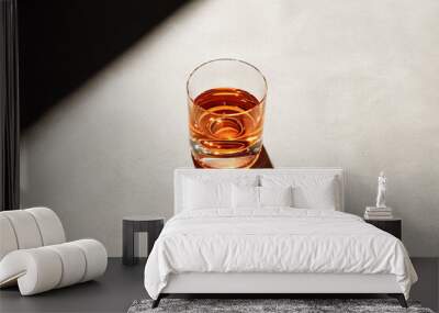 Glass of elegant straight or neat whiskey on a bar counter with dark moody atmosphere. Drink art Wall mural