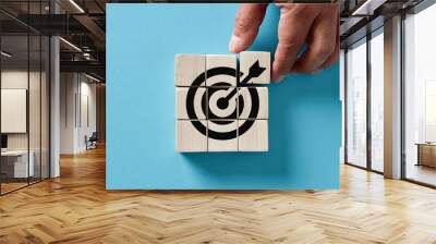 male hand arranging wooden cubes with target icon. business strategy, action plan, goal setting, ach Wall mural