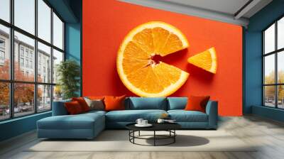 Orange slice symbolizing vitamin c is eating the cut out piece on orange background Wall mural