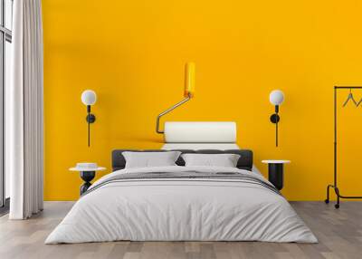 Paint roller brush painting a white line on yellow background. Wall mural