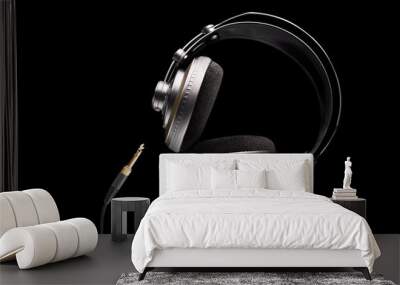 Professional studio headphones and jack on isolated black background Wall mural