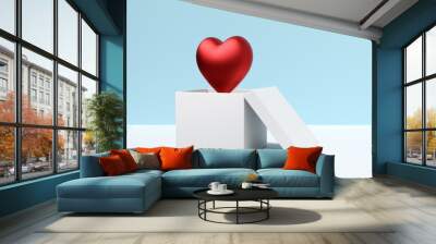 Red heart floating out of open white gift box on blue background Wall mural